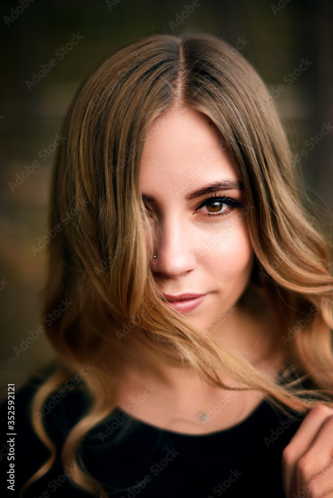 Fototapeta premium A beautiful young girl in fir tree forest