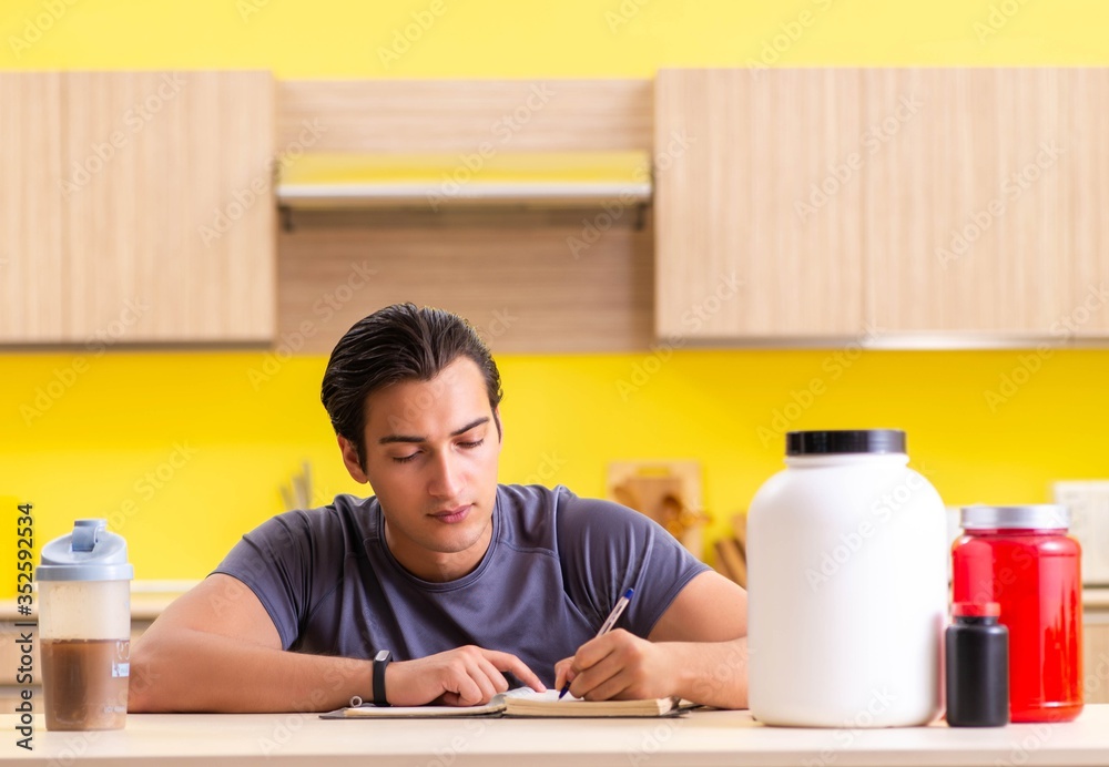 Young man blogging about food supplements Young man blogging about food supplements
