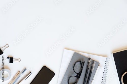 Flat lay, top view office table desk. Workspace with blank note book, keyboard on white background.