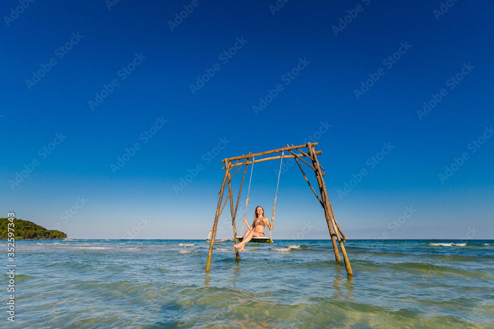 Fototapeta premium Young woman on swing Phu Quoc