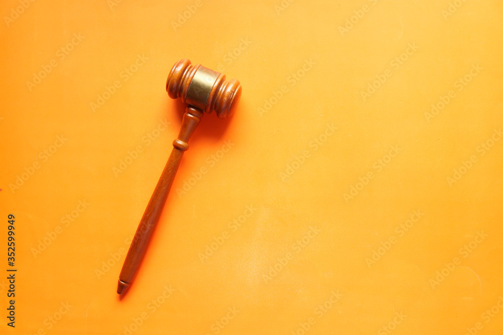 Top view of gavel on orange background Top view of gavel on orange background