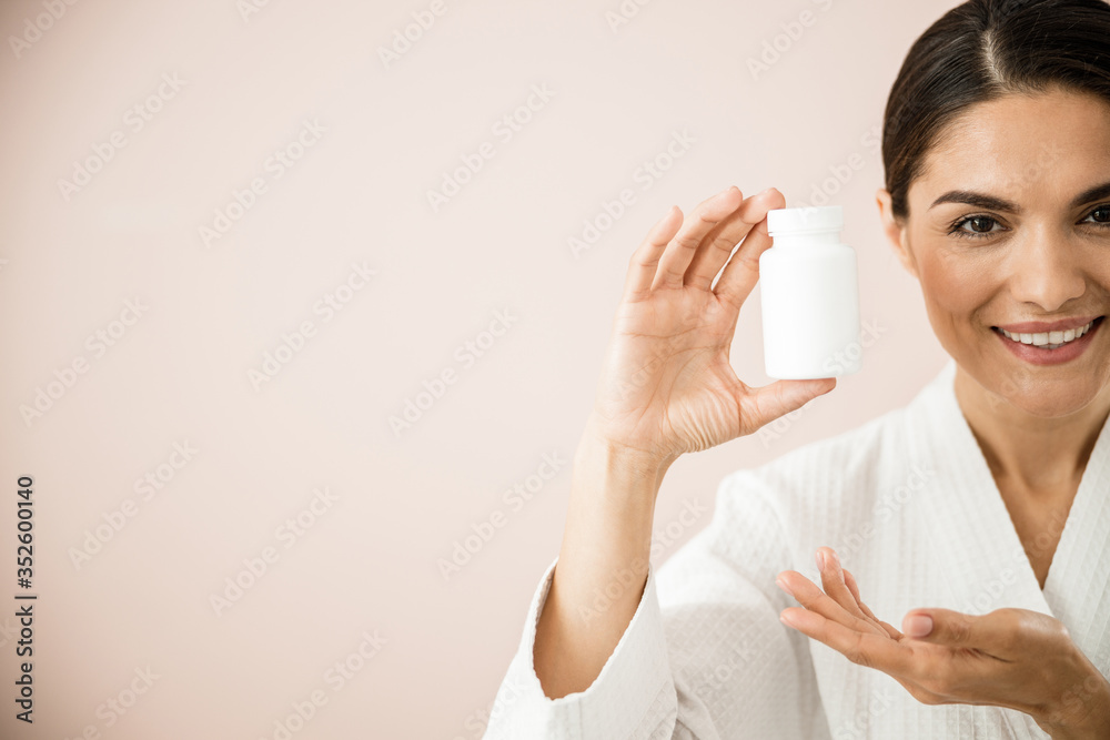 Happy attractive female with vitamins for face and beauty Happy attractive female with vitamins for face and beauty