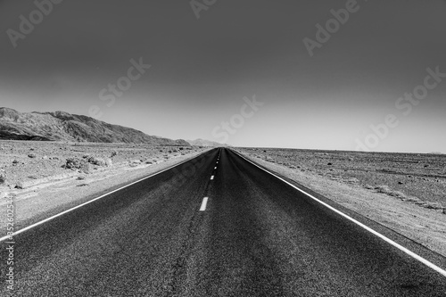 empty road through the death valley desert