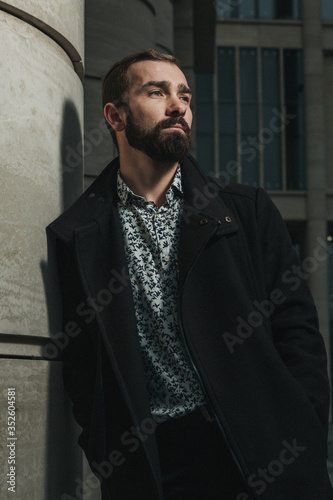 Obraz na plátně Street style photo of mid-adult business professional with black beard