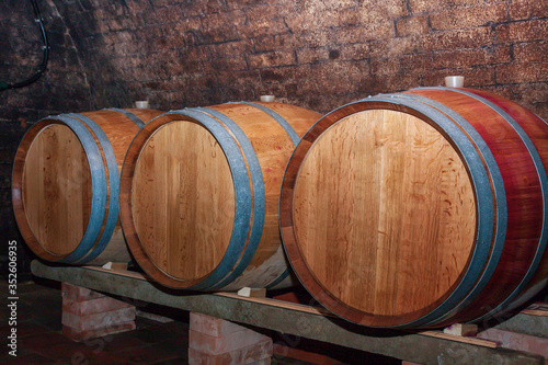 Wooden wine barrels in a wine cellar.