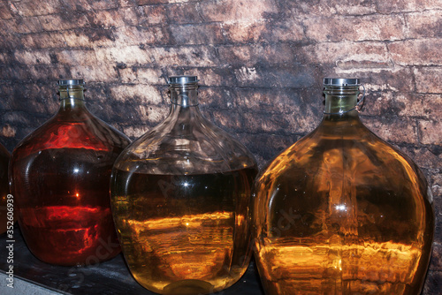Carboys with white and red wine in the wine