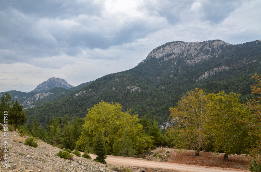 Slopes of the high Taurus mountains with clouds in Turkey in cloudy weather. Travel destination. Trekking and sport. 