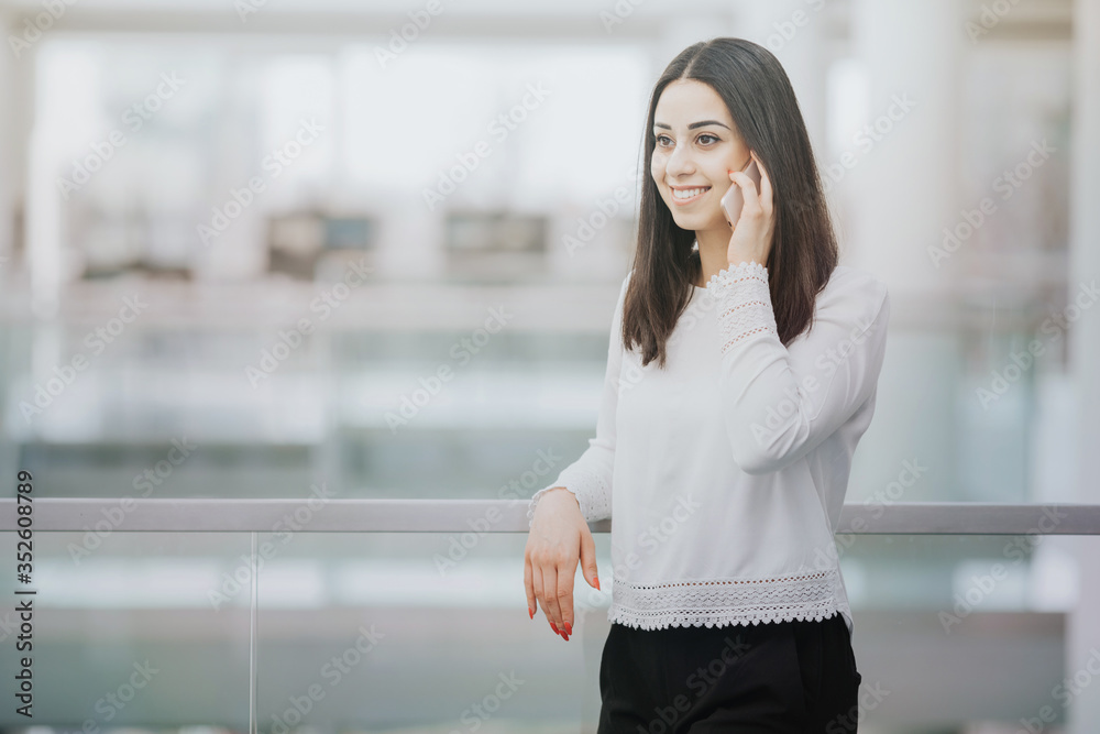 Confident businesswoman talking to a client on the phone Confident businesswoman talking to a client on the phone
