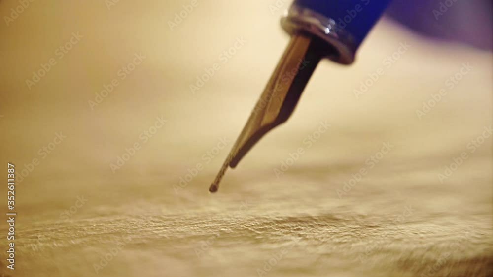 close-up, old ink pen, writes on papyrus words and letters