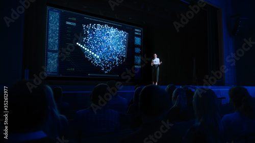 Computer Science Startup Conference  On Stage Speaker Does Presentation of New Product  Talks about Neural Networks  Shows New AI  Big Data and Machine Learning App on Big Screen. Live Event