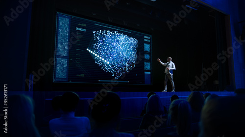 Foto Computer Science Startup Conference: On Stage Speaker Does Presentation of New Product, Talks about Neural Networks, Shows New AI, Big Data and Machine Learning App on Big Screen