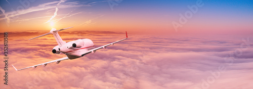 Small private jetplane flying above beautiful clouds. Travel and transportation concept.
