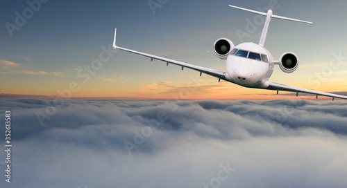 Small private jetplane flying above beautiful clouds. Travel and transportation concept.