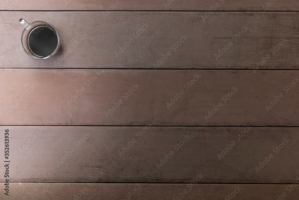 Top view black coffee cup on old wood table. coffee in handle cup with copy space. Hot black coffee with smoke. Top view black coffee cup on old wood table. coffee in handle cup with copy space. Hot black coffee with smoke.