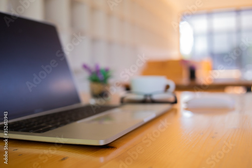 Wallpaper Mural notebook was placed on a table by the window for doing business online at home during the outbreak of the Covid outbreak. Torontodigital.ca
