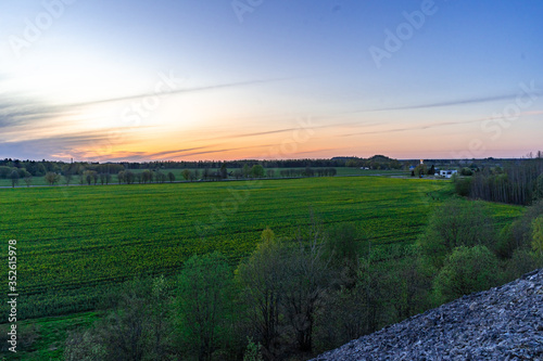 Amazing landscape view from the top of mountain. Forest and green fields.