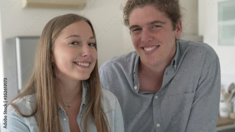 young couple smiling facing camera young couple smiling facing camera