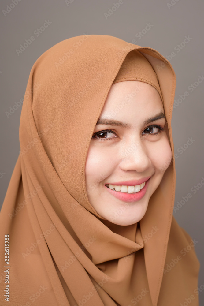 Close up beautiful woman with hijab on gray background Close up beautiful woman with hijab on gray background