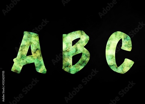 green abstract ABC alphabet letters on black background