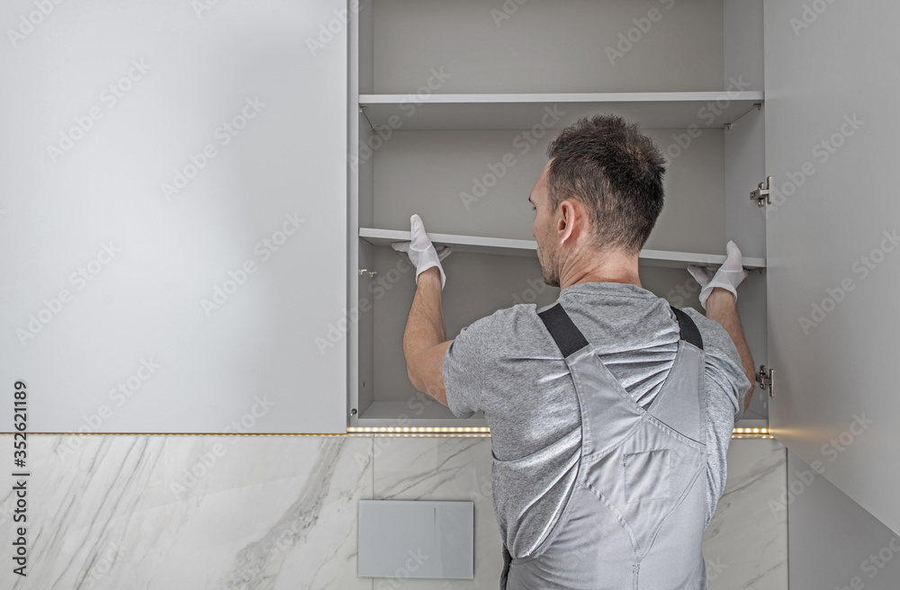 Men Installing Modern Bathroom White Cabinets - obrazy, fototapety, plakaty 