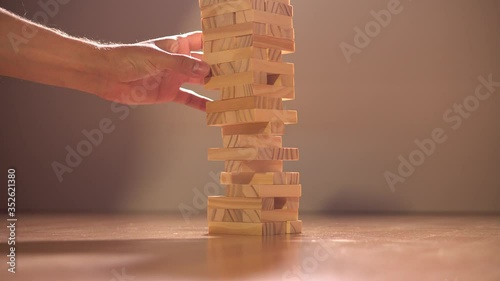 The tower of the Board game jenga falls and falls apart. The concept of risk in business.