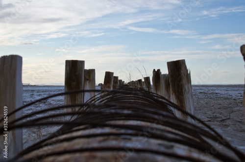 Looking down the pipeline of the wooden water pipe with old wires stick out of the old ruins in utah. 