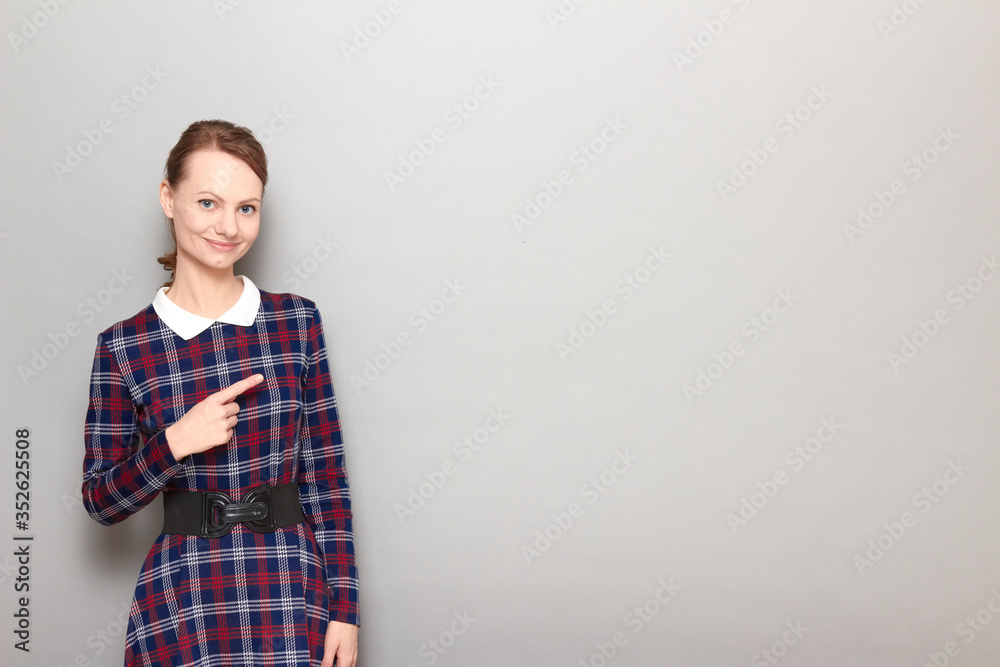 Portrait of happy optimistic girl pointing with finger at copy space Portrait of happy optimistic girl pointing with finger at copy space