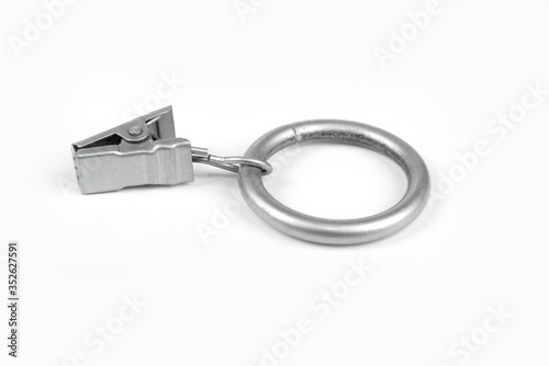 Metal curtain ring with clipper in a white background