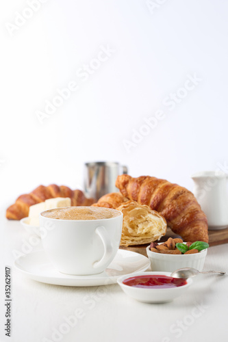 Fresh delicious breakfast with coffee and  croissants