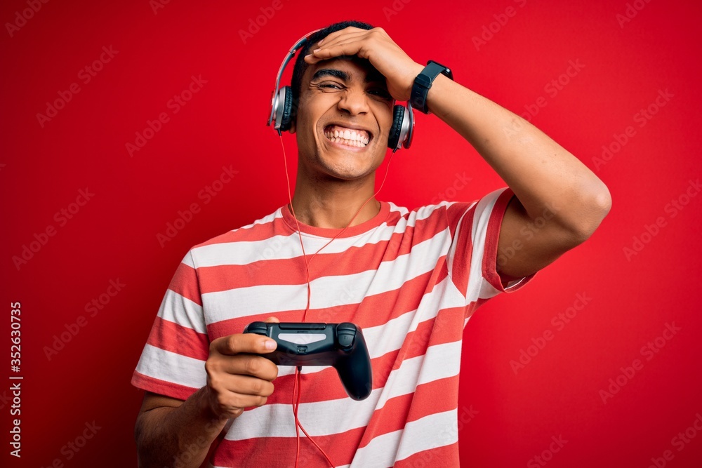 Handsome african american gamer man playing video game using jostick ...