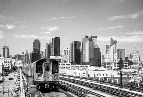train in the city in black and white