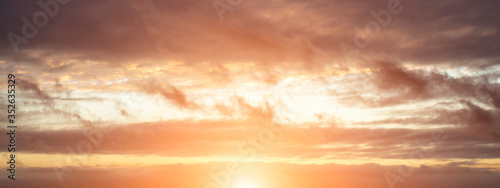 Evening sky with sun flare. Long poster or banner.