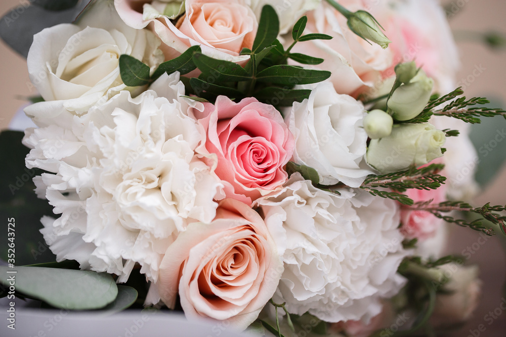 Perfect image with copy space for chic boho wedding magazines and websites, bohemian, fashion, florist. Flowers bouquet with nude roses and wedding rings. Copy space. Flowers background.