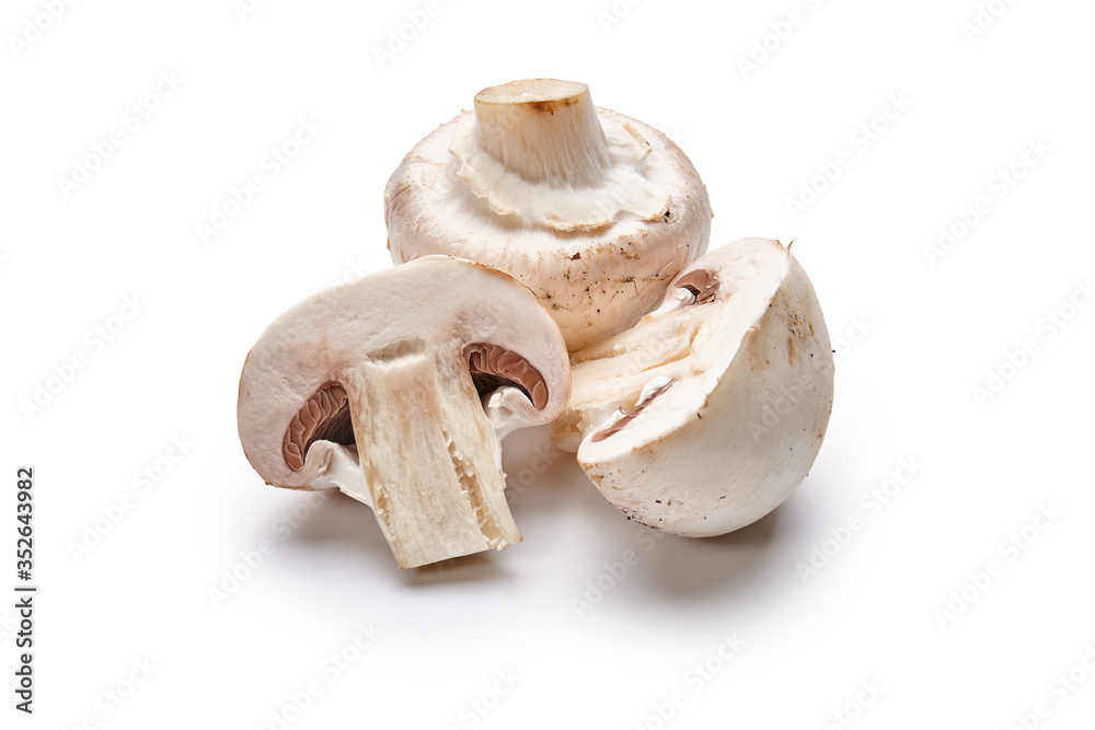 Fototapeta premium White mushrooms lie on a white background