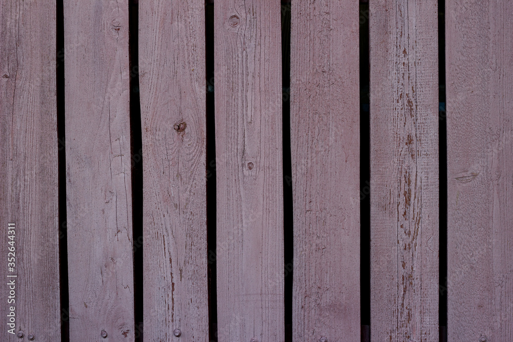 Texture of a red wooden fence made of planks