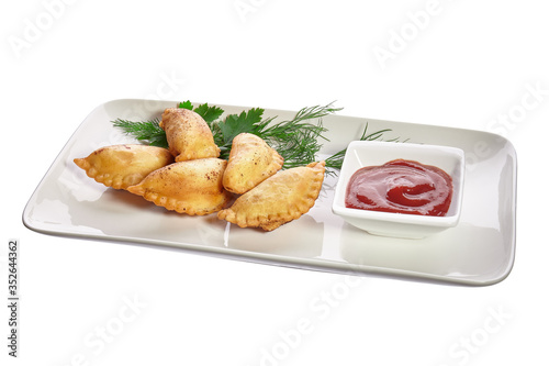 Chebureks on a white plate isolated on a white background