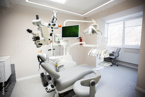 Obraz na płótnie Modern Dental Clinic, Dentist chair and other accessories used by dentists in medical light. Dental surgeon, is a surgeon . Dentist's office. Dental equipment in modern, clean interior w salonie