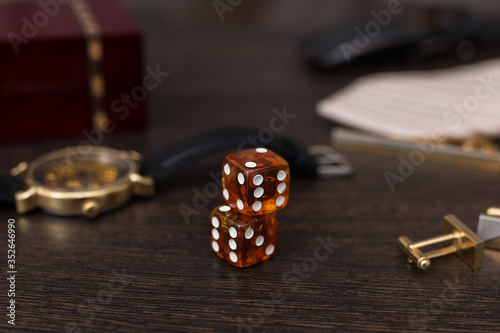 casino gambling, dice close up,amber dice on brown background