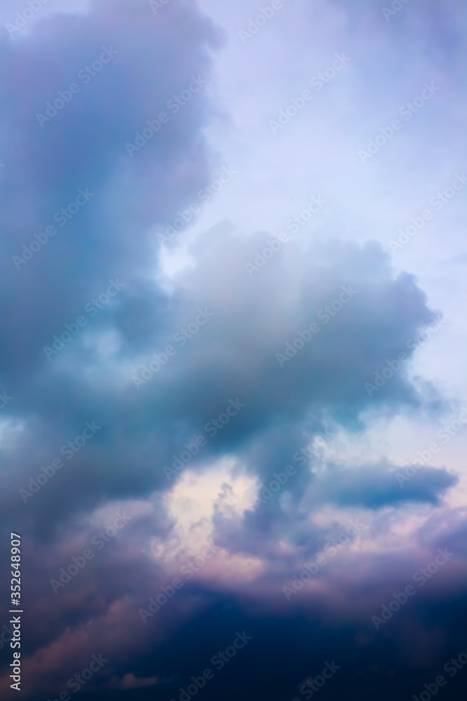 Beautiful purple sky with rainy clouds. Dramatic nature background wallpaper.