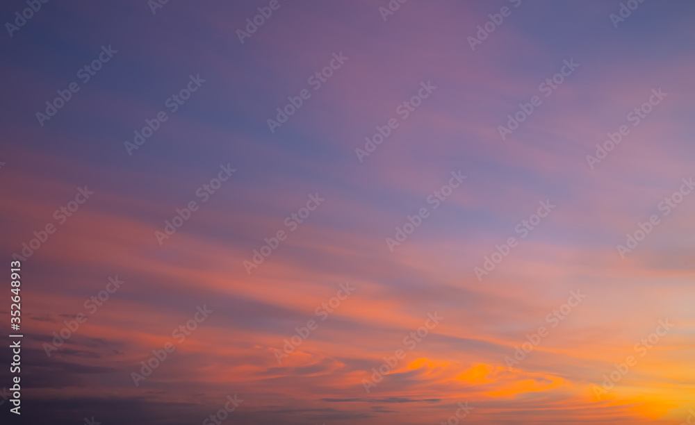 Amazing purple and orange sky with dramatic clouds. Sunset on nature, background wallpaper.