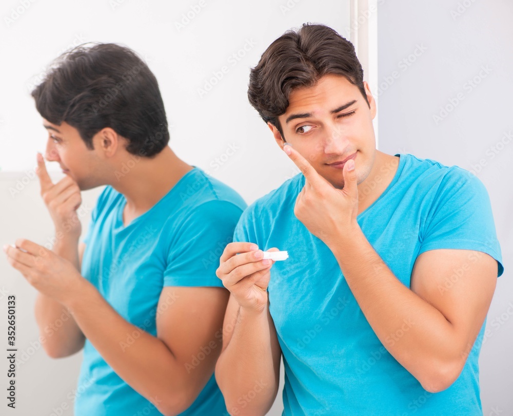 Man trying contact lenses at home Man trying contact lenses at home