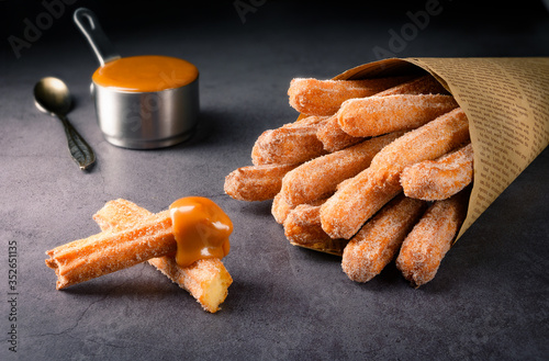 Traditional Churros with sugar and dulce de leche