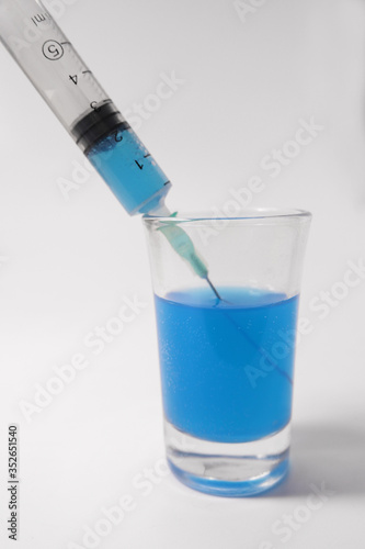 Laboratory tests. Syringe with blue toxin. New antiviral drug.