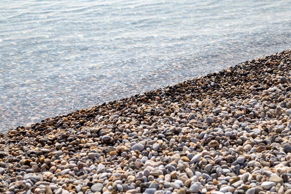 Natural background seashore and stones, pebble sea wave, landscape for calm