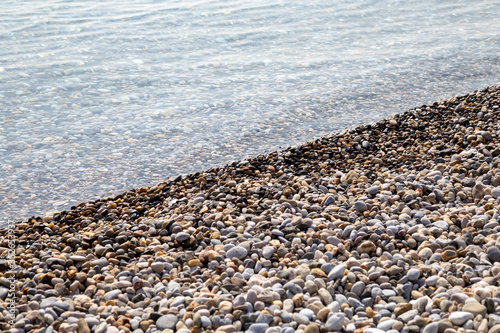 Natural background seashore and stones, pebble sea wave, landscape for calm