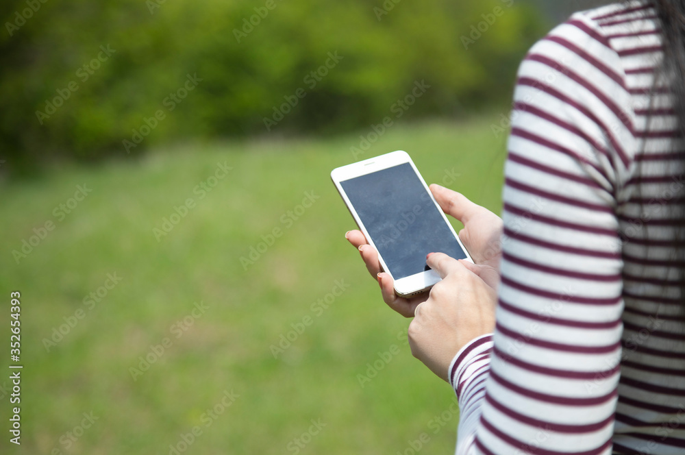 woman hand phone in nature