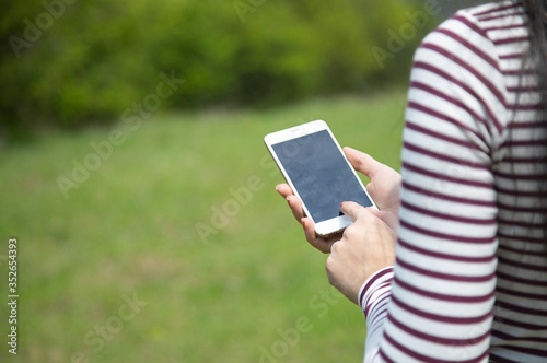 woman hand phone in nature
