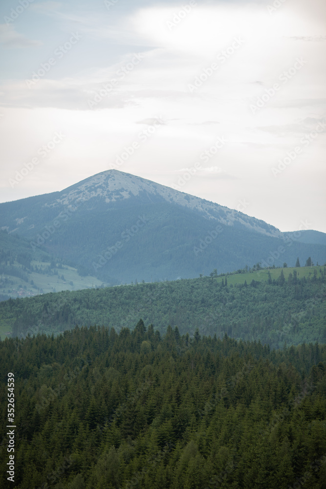 Summer landscape in mountains and the dark blue sky with clouds. Carpathians, Ukraine. Journey in the mountains. Hiking Travel Lifestyle concept beautiful mountains landscape on background.