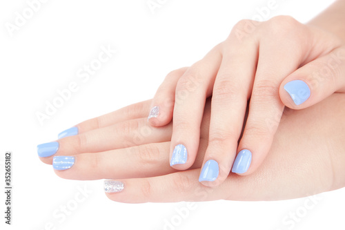 Beautiful female hands with a trendy manicure on white background