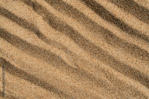 background texture of yellow sand with wavy pattern